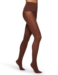 A model's legs wearing sheer brown tights, shown from the waist down against a plain white background.